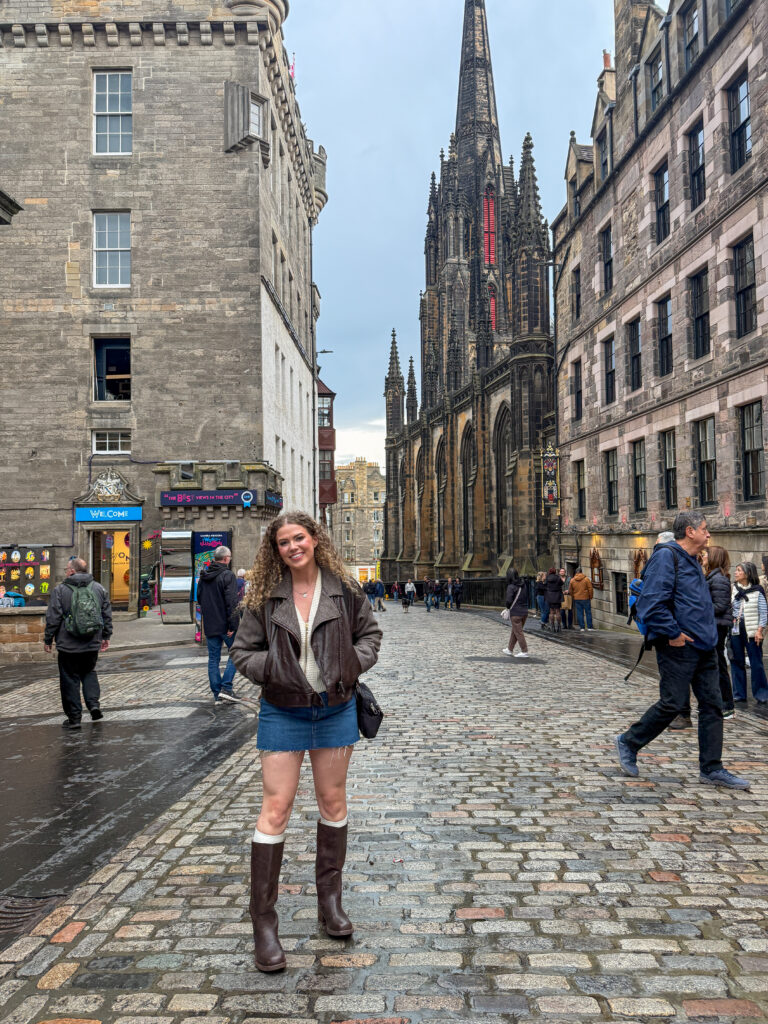 Girl on the historic Royal Mile, Edinburgh, Scotland. Explore Edinburgh history with Royal Mile guided tours in Edinburgh. 