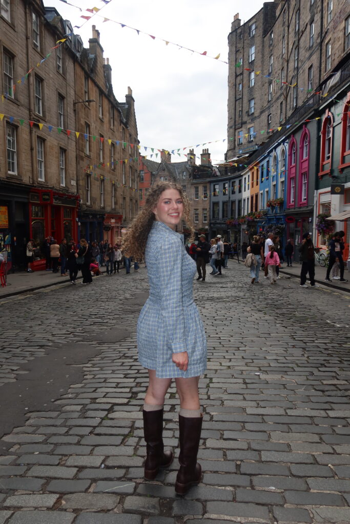Girl on Victoria Street, Edinburgh, a popular stop on Harry Potter guided tours in Edinburgh.  