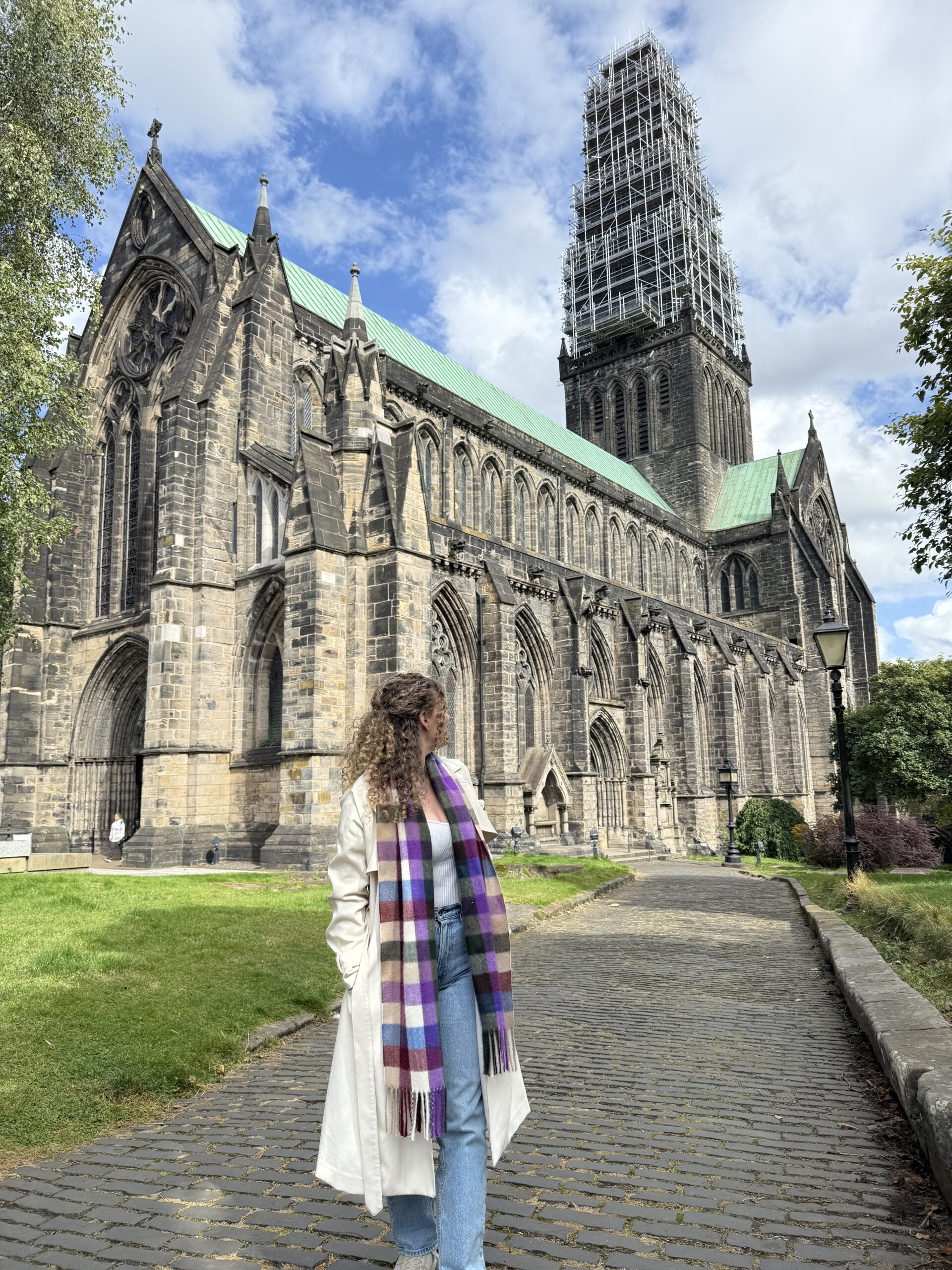 Woman standing in front of Glasgow Cathedral, one of the top things to do in Glasgow